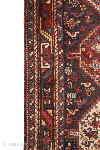 An antique Khamseh rug with a wonderful design and a very practical, almost square size.
The rug features two sets of medallions, each filled with numerous birds. These birds are repeated throughout the ...