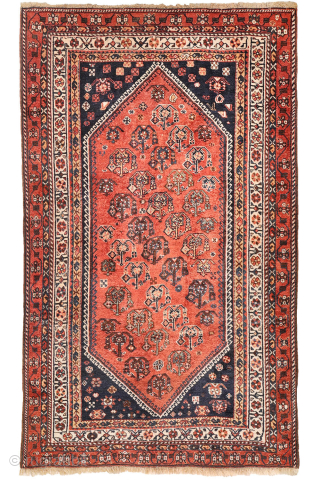 A lovely antique Luri rug with a field filled with elegantly rendered palmettes, arranged diagonally by colour. The spaces left between the main motifs are enriched with scattered decorative elements.. The navy ...