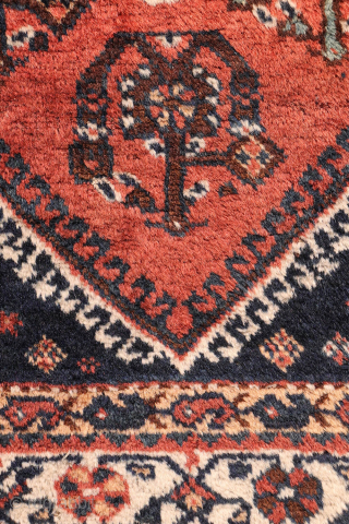 A lovely antique Luri rug with a field filled with elegantly rendered palmettes, arranged diagonally by colour. The spaces left between the main motifs are enriched with scattered decorative elements.. The navy ...