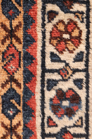 A lovely antique Luri rug with a field filled with elegantly rendered palmettes, arranged diagonally by colour. The spaces left between the main motifs are enriched with scattered decorative elements.. The navy ...