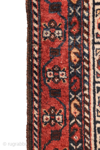 A lovely antique Luri rug with a field filled with elegantly rendered palmettes, arranged diagonally by colour. The spaces left between the main motifs are enriched with scattered decorative elements.. The navy ...