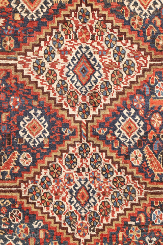 An antique Khamseh rug featuring three large medallions arranged horizontally, extending almost to the rug’s borders. The deep navy-blue field is richly decorated with birds, botehs, S-shaped motifs, and delicate vegetal elements.

The  ...