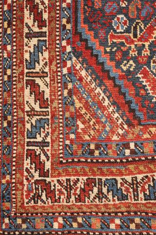 An antique Khamseh rug featuring three large medallions arranged horizontally, extending almost to the rug’s borders. The deep navy-blue field is richly decorated with birds, botehs, S-shaped motifs, and delicate vegetal elements.

The  ...