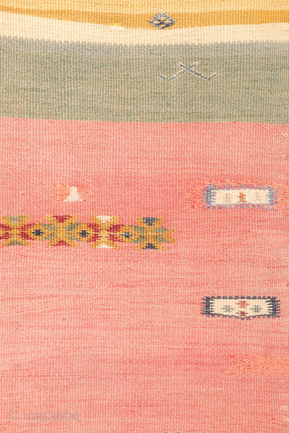 This antique Balikesir kilim features a rare and distinctive design, reminiscent of some early 1800s Balikesir Yuncu kilims. The central field is adorned with enigmatic motifs, seemingly depicting small, intricate rugs. The  ...