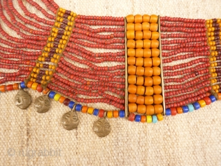 Antique Nagaland necklace with 16 glass strands, 20 brass heads and a shell for clossing. Complete and all original (including the dirt). 650 grams, about 1 metre.      
