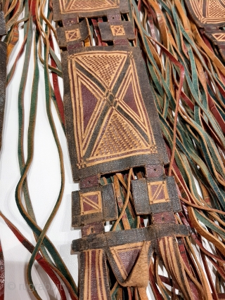 Tuareg leather womans travel bag ("aghrig"), with hand worked and dyed leather, probably goat skin. Intricate leather work with check pattern cut into dyed skin and embroidered thread patterns. The green dyed  ...