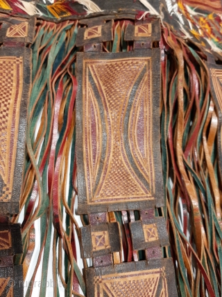 Tuareg leather womans travel bag ("aghrig"), with hand worked and dyed leather, probably goat skin. Intricate leather work with check pattern cut into dyed skin and embroidered thread patterns. The green dyed  ...