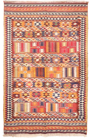 This  Qashqai kilim features a horizontal layout made up of bands of varying widths. Within these bands, the weaver incorporated a variety of traditional motifs — most notably the “comb” motif,  ...