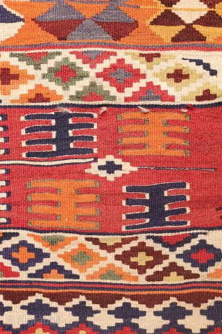 This  Qashqai kilim features a horizontal layout made up of bands of varying widths. Within these bands, the weaver incorporated a variety of traditional motifs — most notably the “comb” motif,  ...
