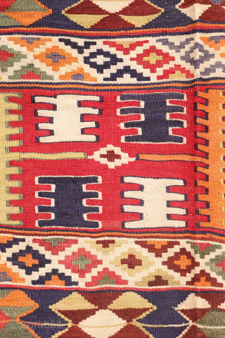 This  Qashqai kilim features a horizontal layout made up of bands of varying widths. Within these bands, the weaver incorporated a variety of traditional motifs — most notably the “comb” motif,  ...