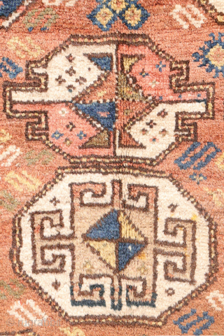 A North West Persian Kurdish rug featuring an oversized design with a large octagon placed in each corner. The central field contains smaller secondary motifs, creating a structured yet lively arrangement.

While the  ...