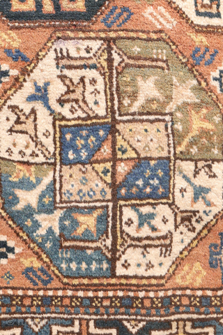 A North West Persian Kurdish rug featuring an oversized design with a large octagon placed in each corner. The central field contains smaller secondary motifs, creating a structured yet lively arrangement.

While the  ...