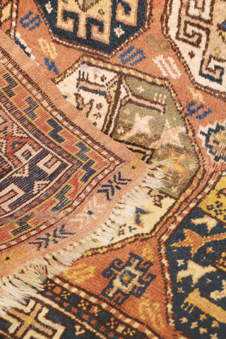 A North West Persian Kurdish rug featuring an oversized design with a large octagon placed in each corner. The central field contains smaller secondary motifs, creating a structured yet lively arrangement.

While the  ...