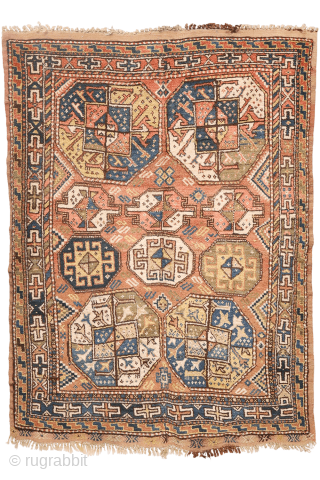 A North West Persian Kurdish rug featuring an oversized design with a large octagon placed in each corner. The central field contains smaller secondary motifs, creating a structured yet lively arrangement.

While the  ...