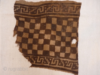 A very bold and graphic pre-columbian Chancay Culture painted textile from Perú, 12th century. This textile shows very powerful interlocked chains of snakes framing a chessboard central motive. It was used as  ...