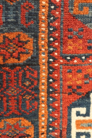 rug from the Baluch tribe, Iran. This poshti or pushti  has an unusual design and the colors are also unusual and include blue and ochre. The border is made up of  ...