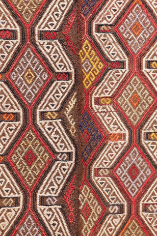 An Adana kilim with a distinct tribal character.
This Adana kilim is woven on an undyed brown wool background and decorated using the cicim technique. While the weaver created a repetitive pattern, she ...