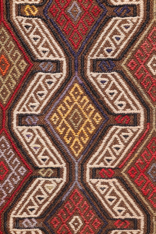 An Adana kilim with a distinct tribal character.
This Adana kilim is woven on an undyed brown wool background and decorated using the cicim technique. While the weaver created a repetitive pattern, she ...