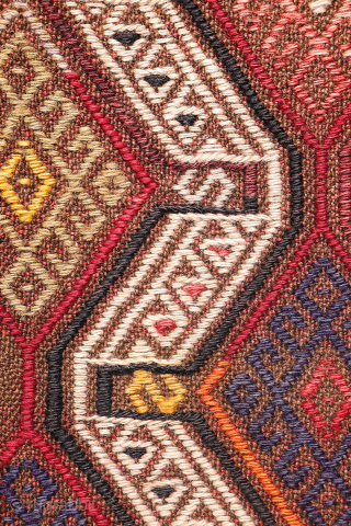 An Adana kilim with a distinct tribal character.
This Adana kilim is woven on an undyed brown wool background and decorated using the cicim technique. While the weaver created a repetitive pattern, she ...