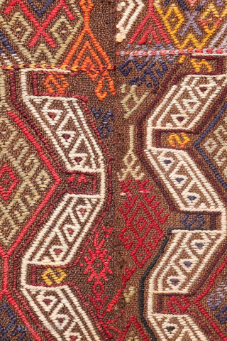 An Adana kilim with a distinct tribal character.
This Adana kilim is woven on an undyed brown wool background and decorated using the cicim technique. While the weaver created a repetitive pattern, she ...