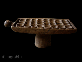 Game board cod. 0149. Carved wood. Luba people. South East region D.R. of Congo. Mid. 20th. century. Good condition with corrosion to the leg. Cm. 76 x 34 x 26 h. (2'6" ...