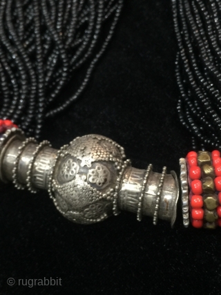 Tribal antique woman necklace from Indus
kohistan valley of Pakistan. The central large bead is silver
while the numerous strands of black beads are glass beads.         