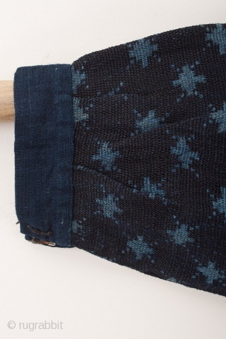 This is a Japanese farmer's jacket made of indigo dyed hemp. What is striking about this jacket is that the garment was first dyed to a pale indigo blue before the rice  ...