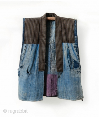 This is a boro sashiko sodenashi, a type of sleeveless hanten, or jacket, typically worn by Japanese farmers. 

The outer fabrics are comprised of solid indigo cotton. A kasuri yoke and lapel  ...