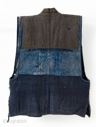 This is a boro sashiko sodenashi, a type of sleeveless hanten, or jacket, typically worn by Japanese farmers. 

The outer fabrics are comprised of solid indigo cotton. A kasuri yoke and lapel  ...
