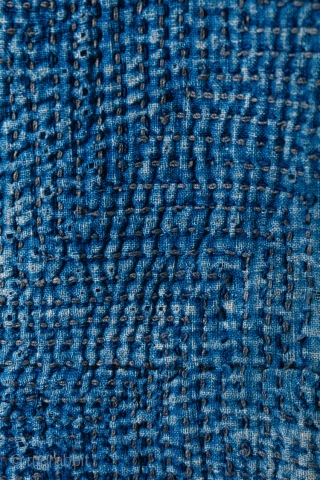 This is a boro sashiko sodenashi, a type of sleeveless hanten, or jacket, typically worn by Japanese farmers. 

The outer fabrics are comprised of solid indigo cotton. A kasuri yoke and lapel  ...
