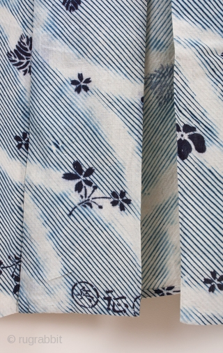 This is a shibori yukata. The shibori process is arashi shibori, where the cloth is wrapped around a pole and then dyed. Then the cloth was further dyed via katazome. The floral  ...