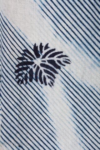 This is a shibori yukata. The shibori process is arashi shibori, where the cloth is wrapped around a pole and then dyed. Then the cloth was further dyed via katazome. The floral  ...