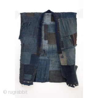 This is a boro sodenashi, or sleeveless jacket. This garment is part of a Japanese farmer's work wear and is well worn, carefully patched, and mended. It's ground is comprised of beautiful  ...