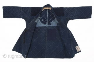 This is cotton noragi or Japanese worker's jacket. Made entirely of indigo, this noragi's hand-stitched sashiko design is a simple and geometric diamond pattern. From the characters sewn to the inside of  ...