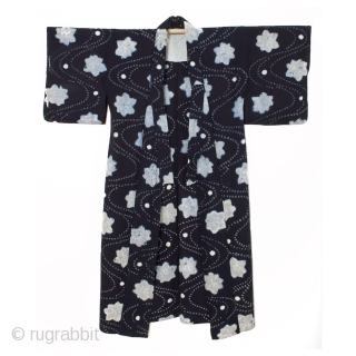 This is a Japanese indigo dyed cotton shibori kimono. A combination of shibori dying techniques are used to achieve this beautiful stream and maple leaf motif. The meandering stream pattern is made  ...