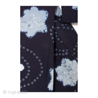 This is a Japanese indigo dyed cotton shibori kimono. A combination of shibori dying techniques are used to achieve this beautiful stream and maple leaf motif. The meandering stream pattern is made  ...