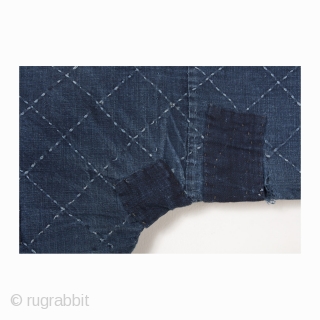 This is cotton noragi or Japanese worker's jacket. Made entirely of indigo, this noragi's hand-stitched sashiko design is a simple and geometric diamond pattern. From the characters sewn to the inside of  ...