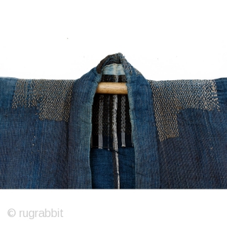 This is an antique Japanese boro farmer's workwear jacket called a noragi. 

The textile is made of hand spun cotton which has been dyed in natural, botanical indigo and woven into a  ...