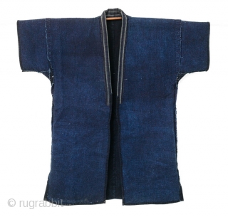 This is a Japanese sashiko noragi, or quilted coat, from Shonai, Yamagata prefecture of Japan. 

This jacket's entire surface is dyed with a deep natural indigo and is densely sashiko stitched. The  ...
