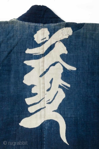 This is a large Japanese indigo dyed jacket, or hanten, decorated with a rice paste resist dye technique. It is very likely that a stencil was used though the appearance has an  ...