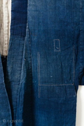 This is a large Japanese indigo dyed jacket, or hanten, decorated with a rice paste resist dye technique. It is very likely that a stencil was used though the appearance has an  ...