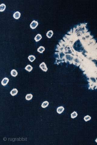 This is a vintage Japanese cotton textile fragment decorated with mixed shibori tie-dye techniques of kanoko (spaced dots), boshi (capped circles), and shapes, perhaps of fundo weights. The pattern is relaxed and  ...