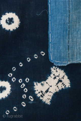 This is a vintage Japanese cotton textile fragment decorated with mixed shibori tie-dye techniques of kanoko (spaced dots), boshi (capped circles), and shapes, perhaps of fundo weights. The pattern is relaxed and  ...