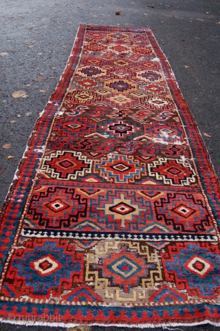 Unusual north west persian runner. Probably shashavan, possibly third quarter of the 19th century. Beautiful colours and lovely wool. Some wear and moth damage. 287 x 74cm.      