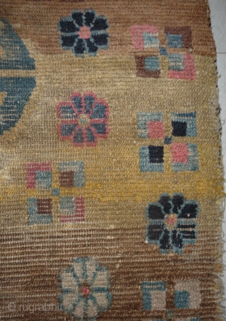 an unusual appealing big tibetan sleeping and/or meditation rug with a totemic like so called shou design and abrashed ground in yellow and brown. what is now called shou design has been  ...