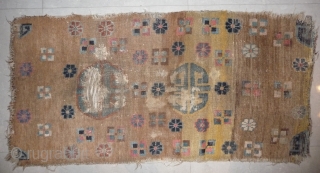 an unusual appealing big tibetan sleeping and/or meditation rug with a totemic like so called shou design and abrashed ground in yellow and brown. what is now called shou design has been  ...