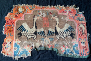 an early 20th century large lama throneback with a powerful bold design. the border diplays the eight auspicious buddhist symbols. thought in fragmentary condition, it is a rare tibetan cultural weaving worth  ...