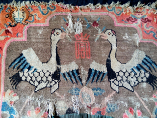 an early 20th century large lama throneback with a powerful bold design. the border diplays the eight auspicious buddhist symbols. thought in fragmentary condition, it is a rare tibetan cultural weaving worth  ...