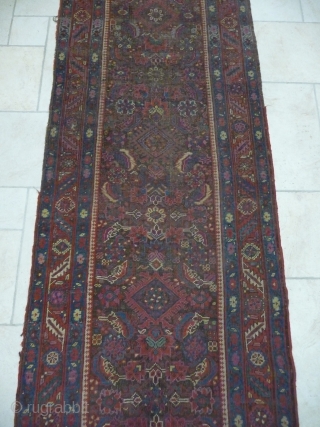 an early north-west persian long rug, possibly kurdish, with a very unusual colour palette, all natural with different purples and light indigo abrash. ends and selvedge partially worn but more or less  ...