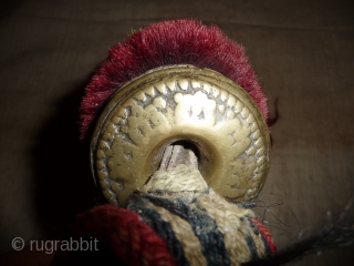 very nice tibetan animal amulet-trapping with cast bell . the band is woven in wool, the bobble under the bell is made of  red-dyed yak hair. the end is a red-dyed  ...